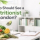 Minimalist nutritionist office setting in London with fresh vegetables, clipboard, and greenery, representing personalised nutrition consultations.